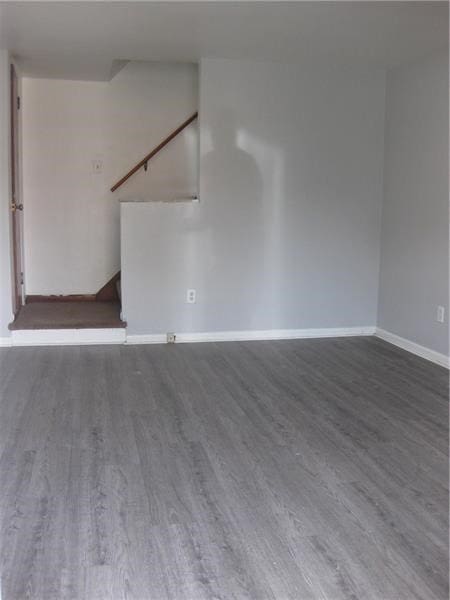 2608 Highland Ave, Mckeesport, PA 15132 - spare room featuring wood finished floors, baseboards, and stairway