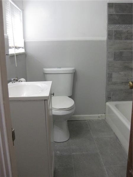 bathroom featuring tile patterned floors, vanity, and toilet