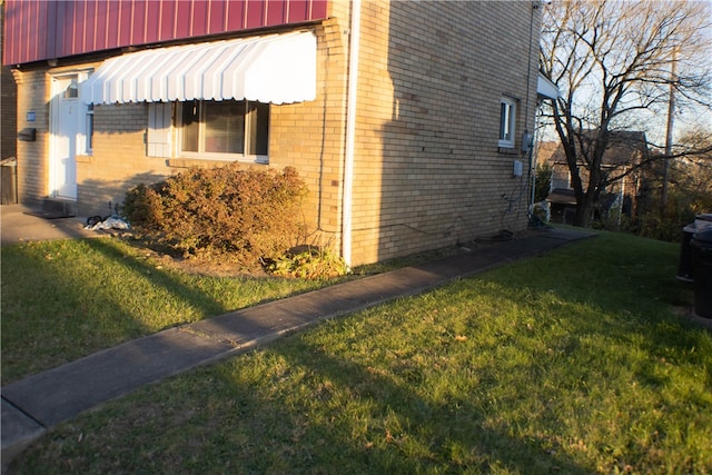 view of home's exterior with a lawn