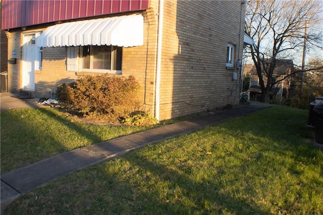 2608 Highland Ave, Mckeesport, PA 15132 - view of property exterior featuring brick siding and a lawn