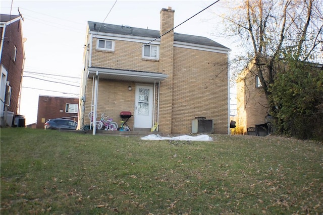 2608 Highland Ave, Mckeesport, PA 15132 - back of property with brick siding, a chimney, and a lawn