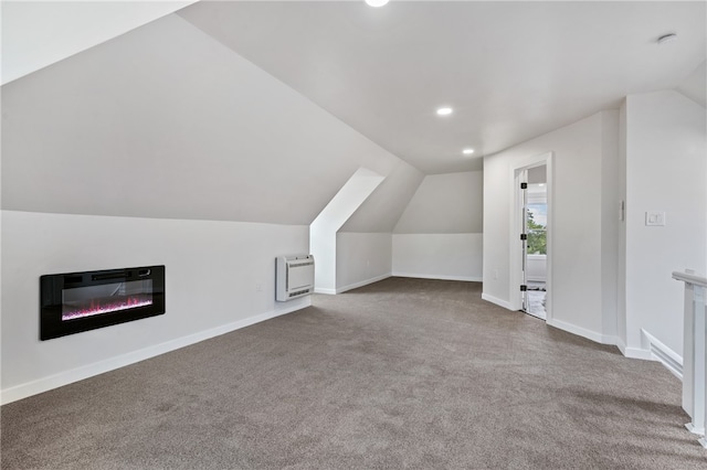 bonus room featuring carpet, heating unit, and vaulted ceiling