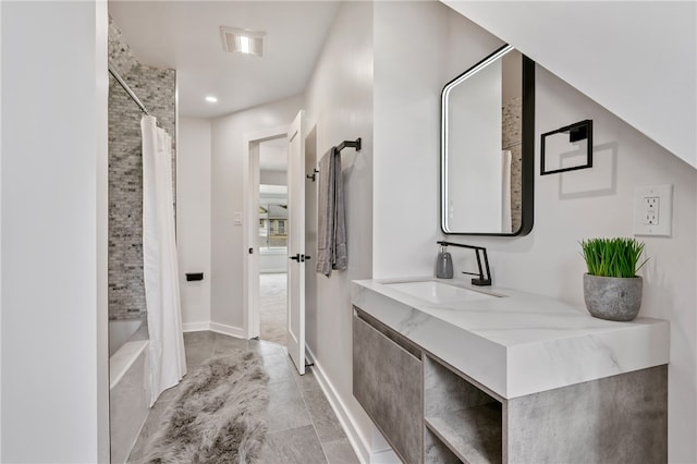 bathroom featuring vanity and shower / bath combo