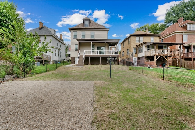 back of property with a lawn