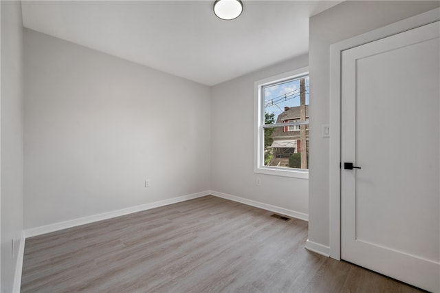 unfurnished room with light hardwood / wood-style flooring