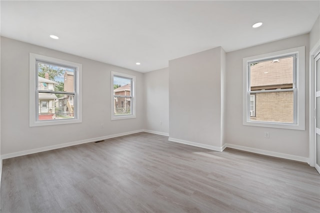 spare room featuring light hardwood / wood-style floors