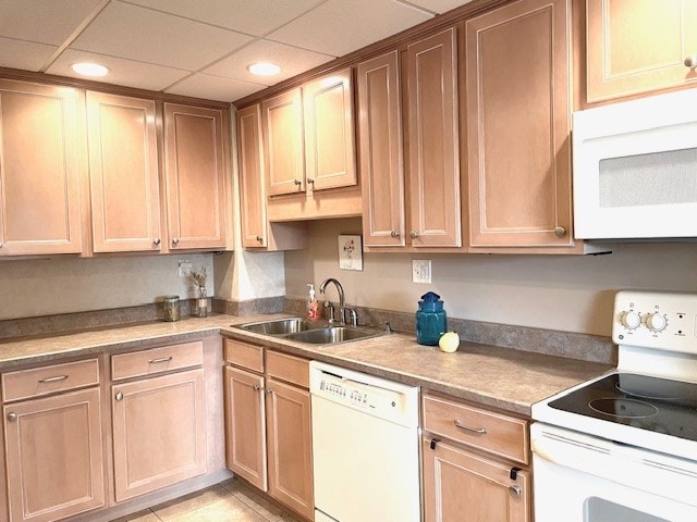 kitchen with sink, light tile patterned floors, and white appliances