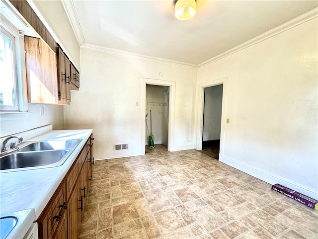 kitchen featuring crown molding, white stove, and sink