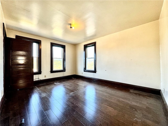 empty room featuring dark hardwood / wood-style flooring