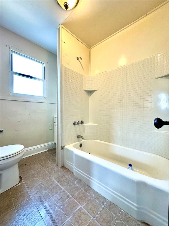 bathroom with toilet, tile patterned floors, and tub / shower combination