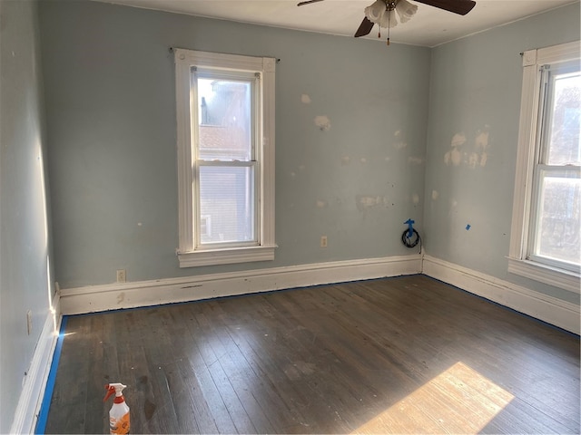 spare room with ceiling fan and dark hardwood / wood-style floors