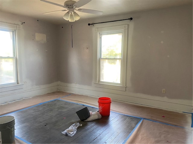 spare room featuring wood-type flooring and ceiling fan