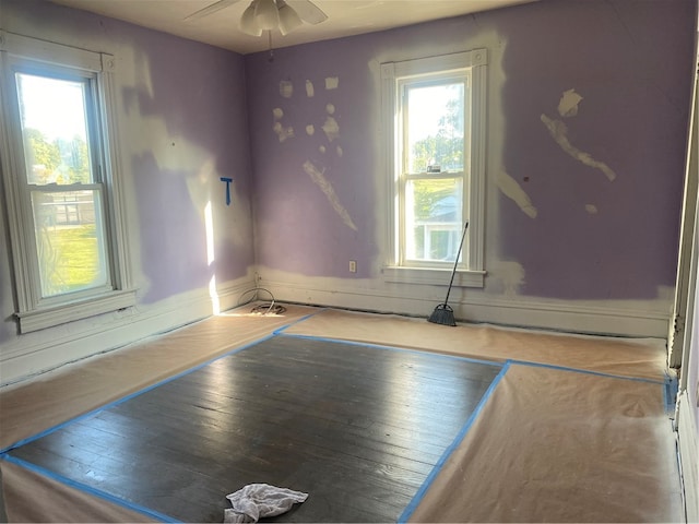 spare room with hardwood / wood-style floors and ceiling fan