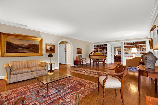 living room featuring built in features, hardwood / wood-style floors, and ornamental molding