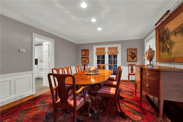 dining space featuring crown molding and dark wood-type flooring