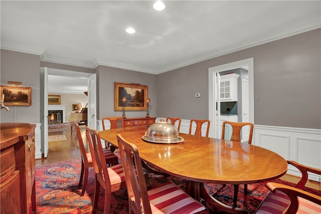 dining room with wood-type flooring and ornamental molding