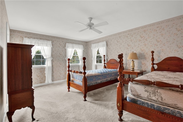 bedroom with ceiling fan and light colored carpet