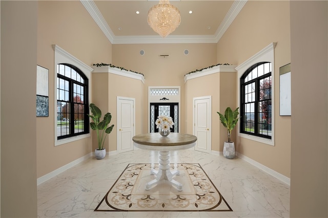 entrance foyer featuring crown molding, a towering ceiling, and a healthy amount of sunlight