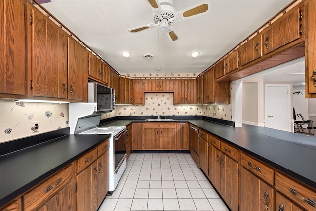 kitchen featuring ceiling fan, sink, light tile patterned floors, and appliances with stainless steel finishes