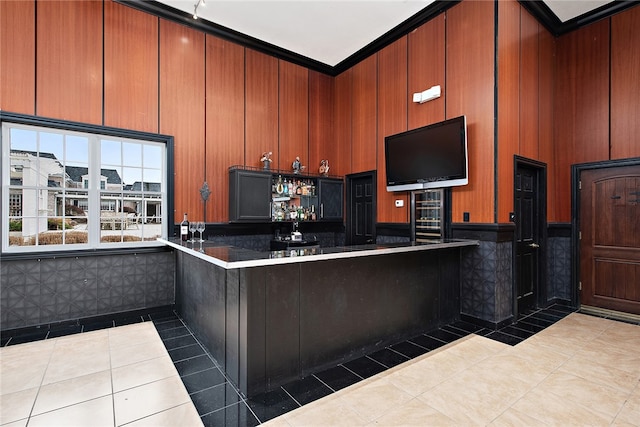 kitchen featuring a high ceiling, light tile patterned floors, and crown molding