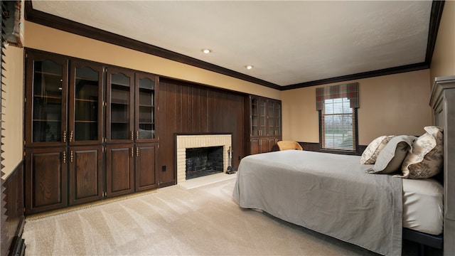 carpeted bedroom with ornamental molding and a brick fireplace