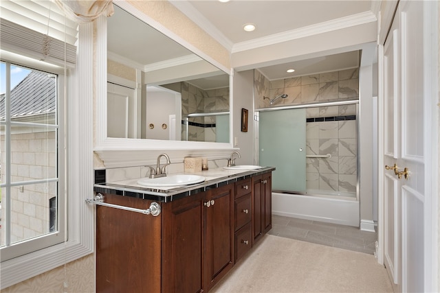 bathroom with crown molding, vanity, enclosed tub / shower combo, and tile patterned flooring