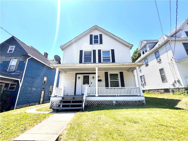 view of front of house with a front yard and a porch