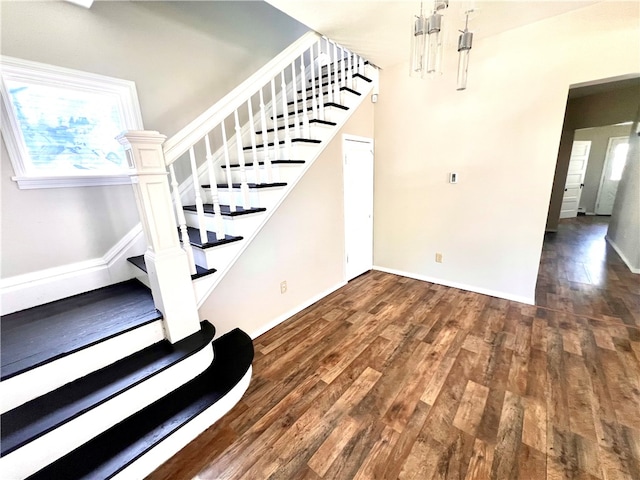 stairs with hardwood / wood-style flooring