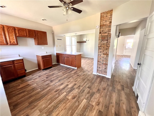 kitchen with kitchen peninsula, ceiling fan, and dark hardwood / wood-style floors