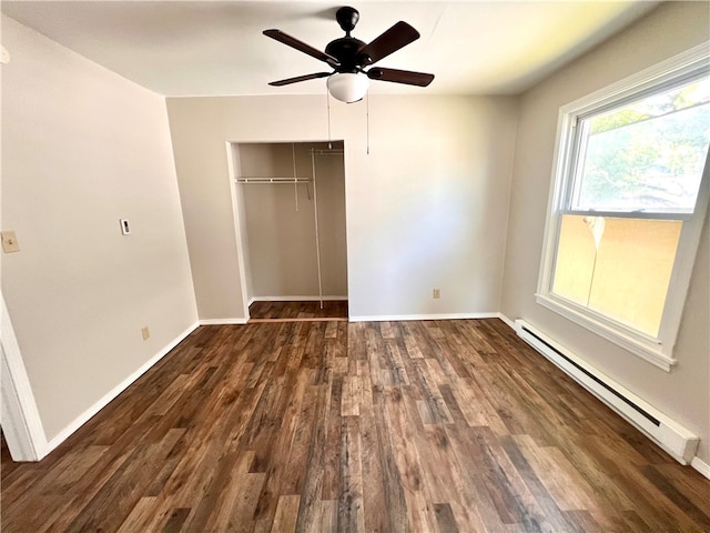 unfurnished bedroom with a baseboard heating unit, a closet, ceiling fan, and dark hardwood / wood-style floors