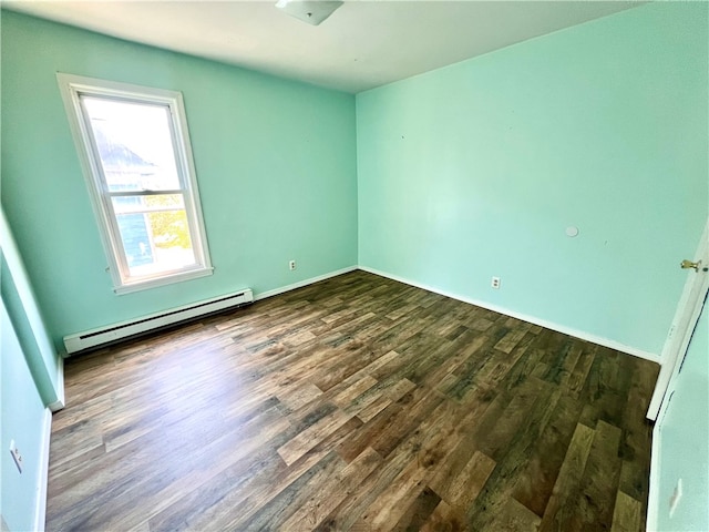 empty room with a baseboard radiator and dark hardwood / wood-style flooring