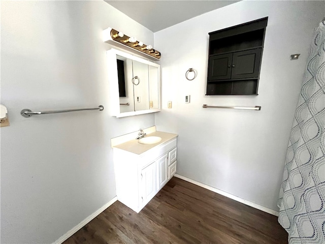 bathroom with vanity and hardwood / wood-style flooring