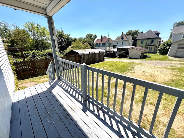 deck with a lawn and a shed