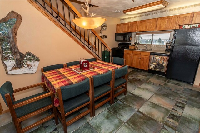 kitchen with sink and black appliances