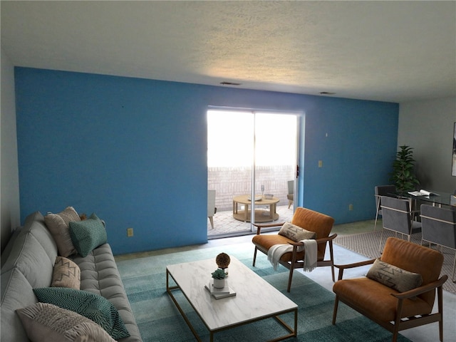 carpeted living room featuring a textured ceiling