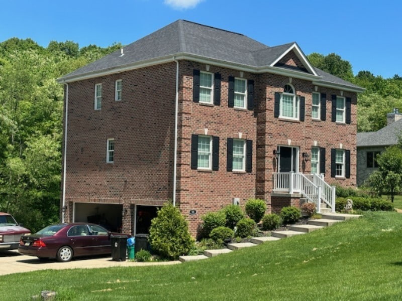 colonial home with a garage and a front lawn