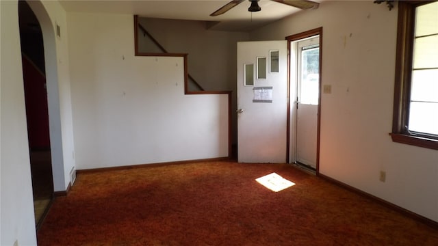 empty room featuring ceiling fan and carpet floors