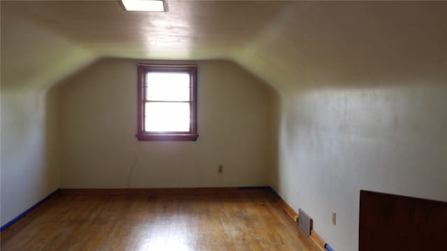 bonus room featuring lofted ceiling and light hardwood / wood-style flooring