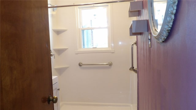 bathroom with walk in shower and vanity