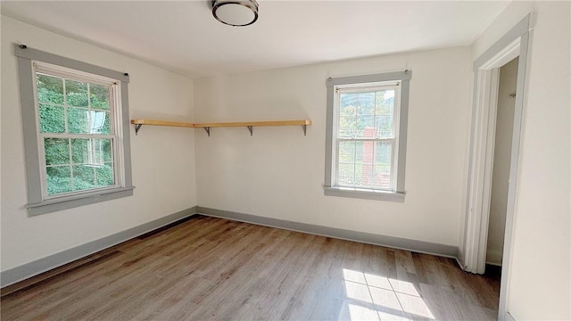 empty room with light wood-type flooring and baseboards