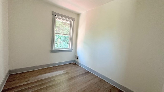 empty room featuring visible vents, baseboards, and light wood-style floors