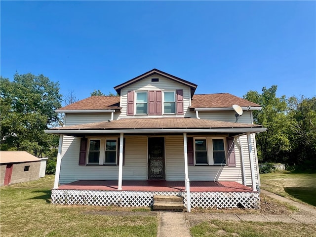 view of front of property with covered porch and a front yard