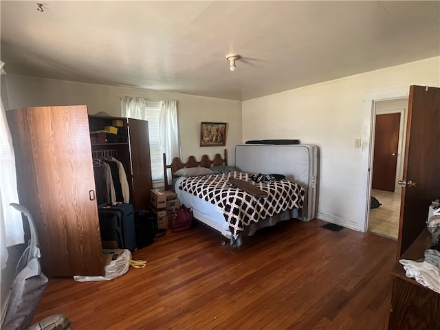 bedroom featuring a closet and dark wood-type flooring