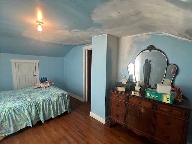 bedroom featuring vaulted ceiling and dark hardwood / wood-style flooring