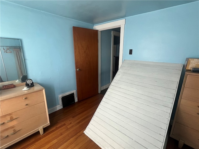 bedroom featuring dark wood-type flooring