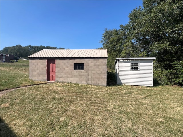 view of outbuilding with a lawn