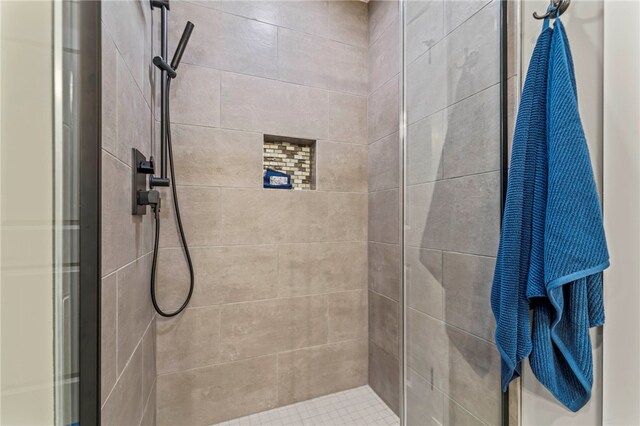 bathroom with a shower with door