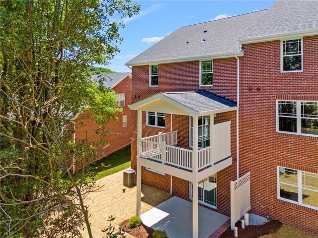 rear view of property featuring central AC unit