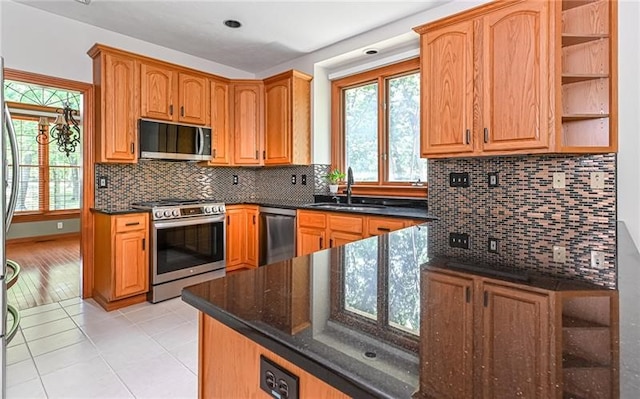 kitchen featuring light hardwood / wood-style flooring, stainless steel appliances, tasteful backsplash, and sink