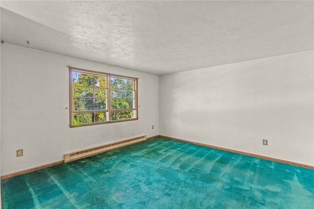 carpeted spare room featuring a baseboard heating unit and a textured ceiling